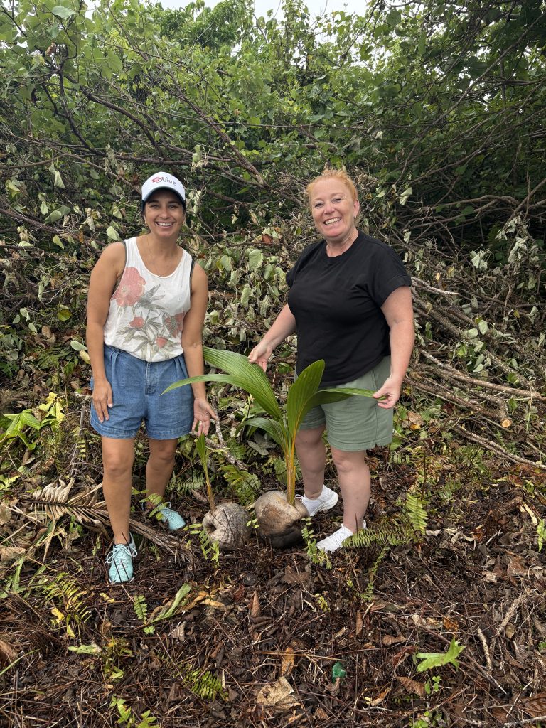 HoT’s Kelly Gainsford and Renee Lomas of Shore Travel planting a coconut palm.